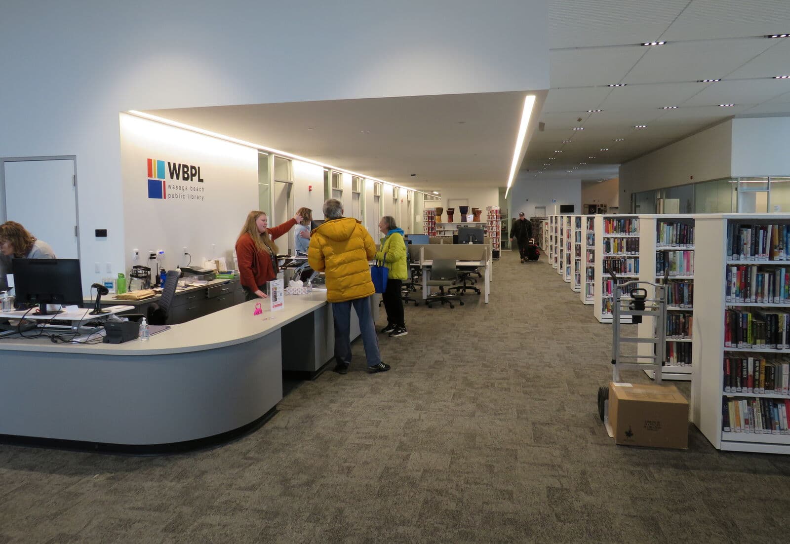 Residents at the service desk inside the Wasaga Beach Public Library