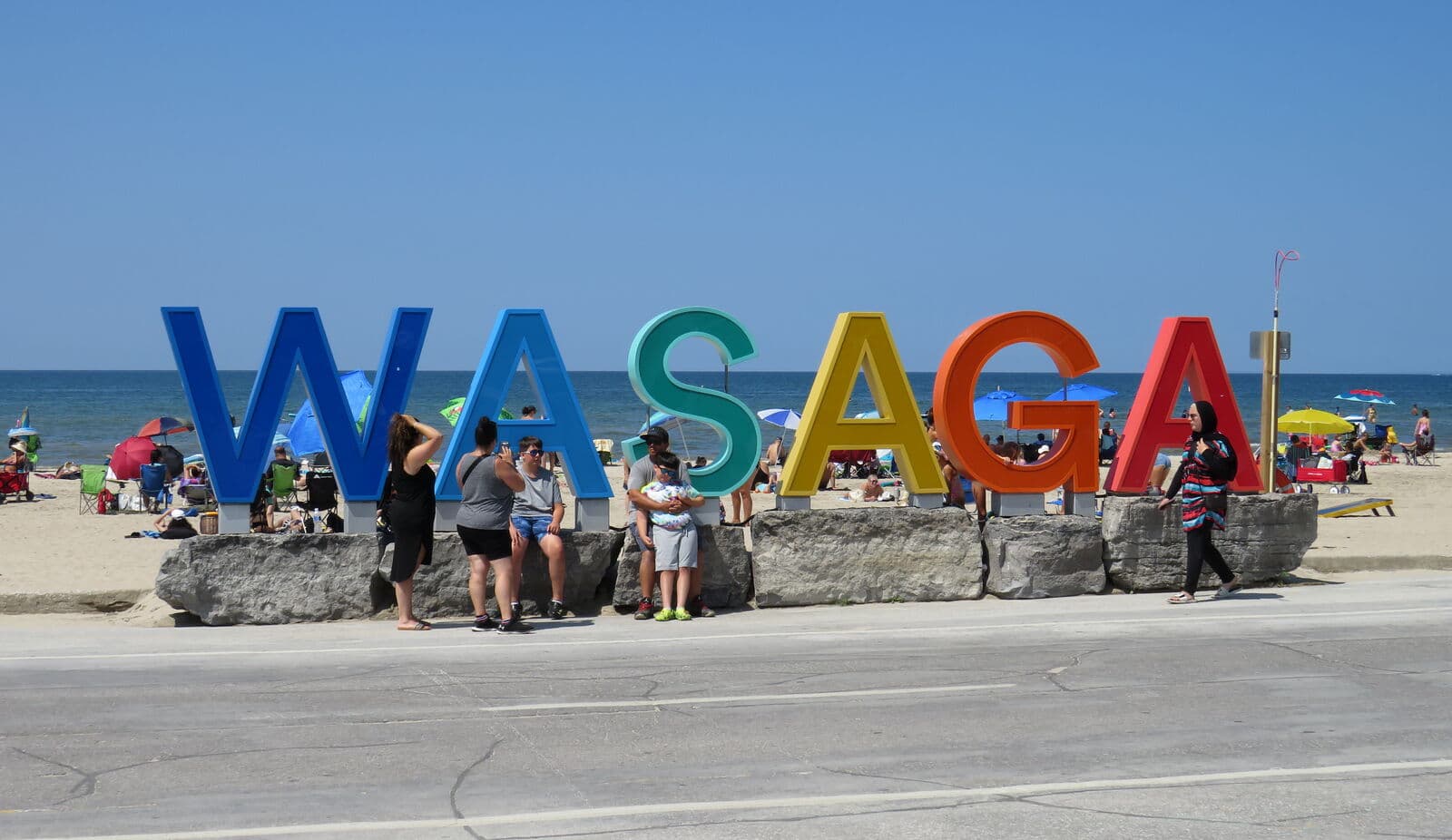 The colourful WASAGA letters at the Beach Area One waterfront on a busy summer day